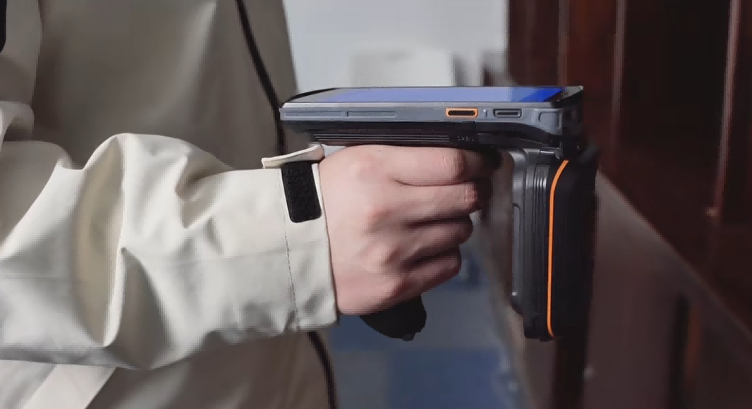 Enterprise RFID asset management using a handheld RFID reader for inventory in a professional warehouse.